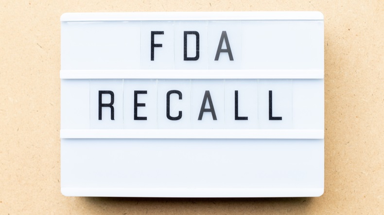 White lightbox with word fda recall on wood background