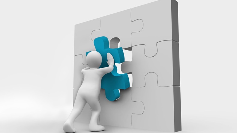 Human representation resolving a jigsaw puzzle - Image ID: D9T78X