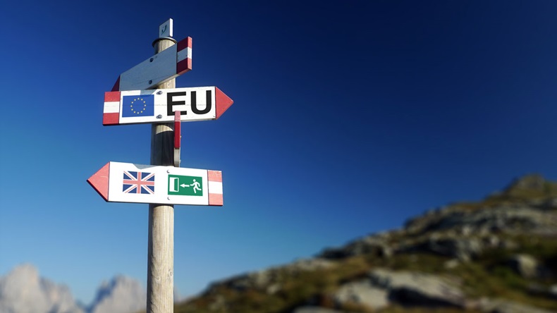 Brexit concept. British flag exit sign and EU flag on mountain road sign.