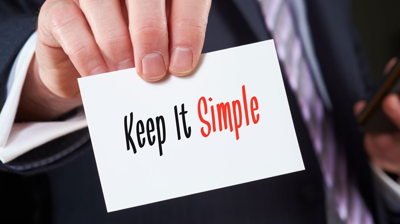 Keep it simple sign held by businessman