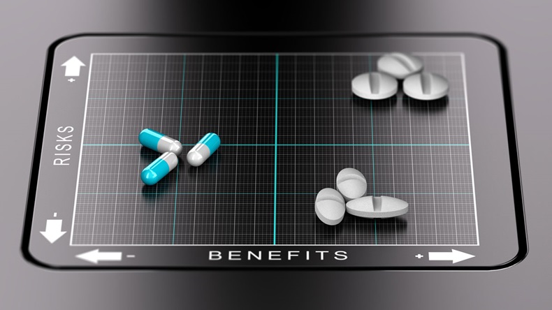 3D illustration of a benefits versus risks matrix with pills and tablets positioned on it. Evaluation of drugs, healthcare concept