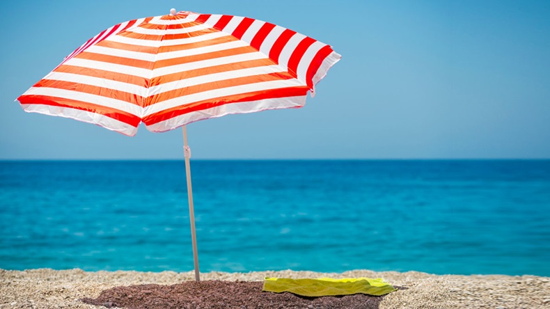 Striped beach umbrella on the beach.