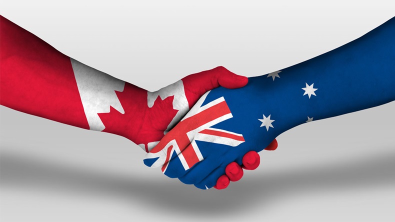 Handshake between Australia and canada flags painted on hands, illustration with clipping path.