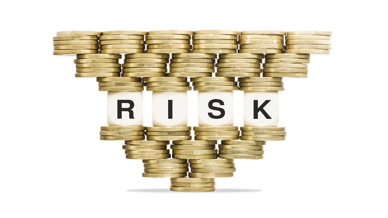 Risk Management Word RISK on Unstable Stack of Gold Coins - Image