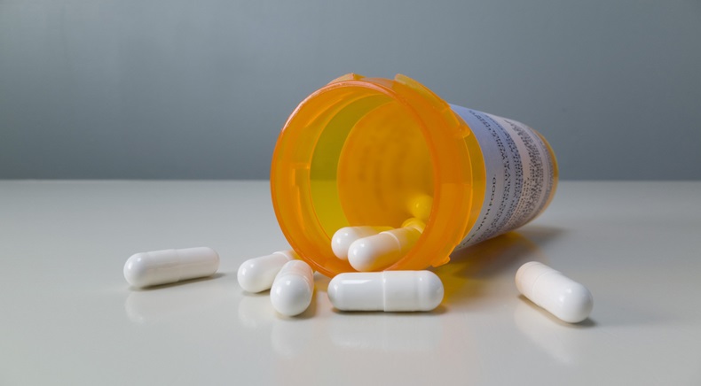 Bottle of Prescription Pills Spilled on the Table - Image 