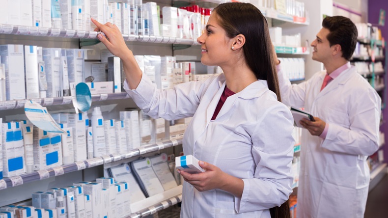 Smiling pharmacist and indian pharmacy technician posing in drugstore - Image 