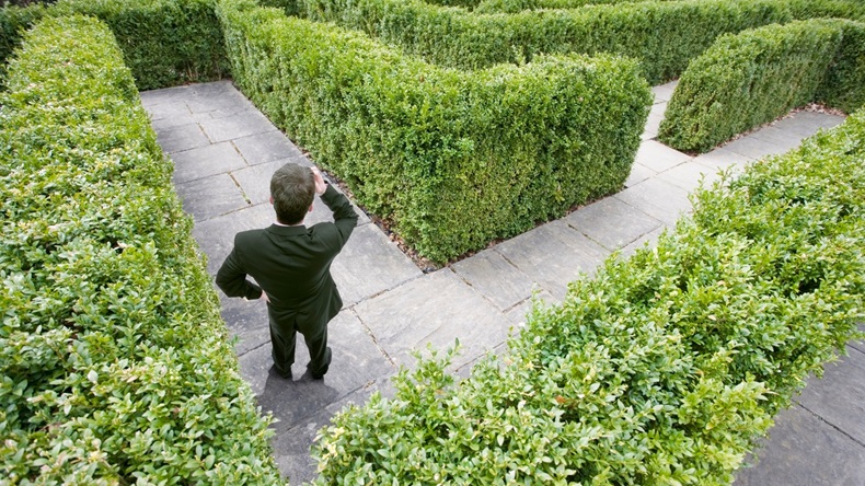Top view of a caucasian businessman lost in a maze - Image 
