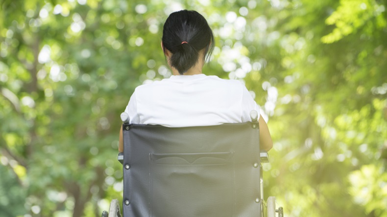 woman using a wheelchair in a park - Image 