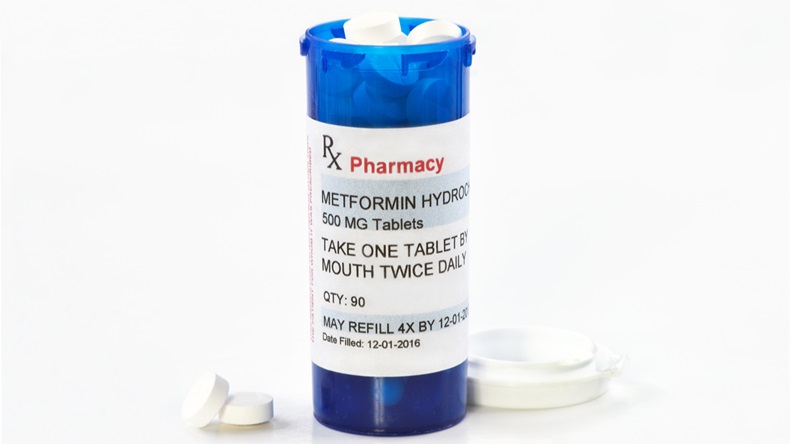 Metformin prescription bottle with tablets and lid. - Image 