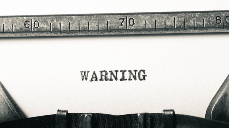 word warning typed on old typewriter