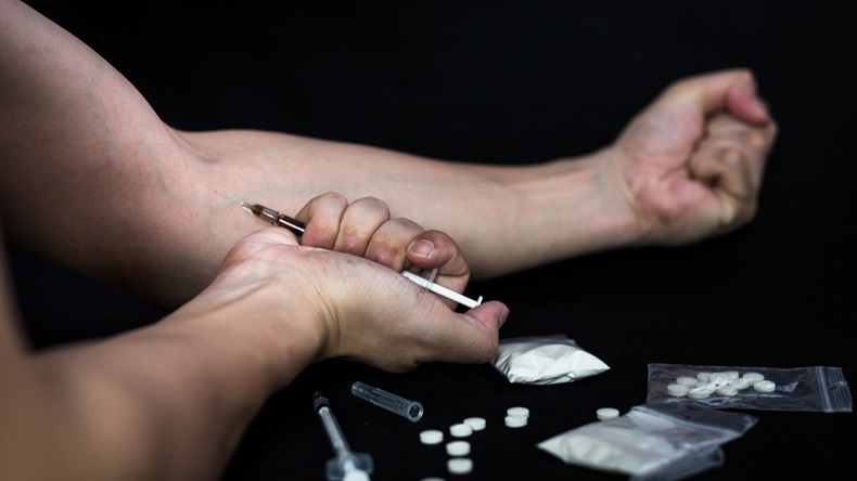Addict man make injection of drugs