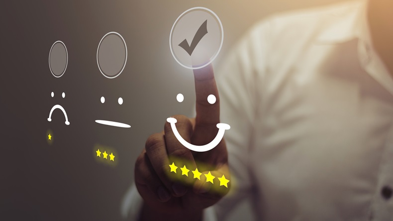 Businessman pressing smiley face emoticon on virtual touch screen. Customer service evaluation concept.