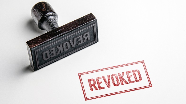 Rubber stamping that says 'Revoked'.