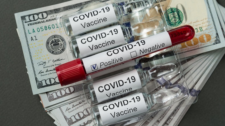test tube with blood for Covid-19 analyzing and ampoules of vaccine are on stack of dollars. Price drugs coronavirus.