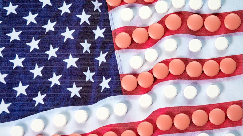 Multicolored pills on American flag background