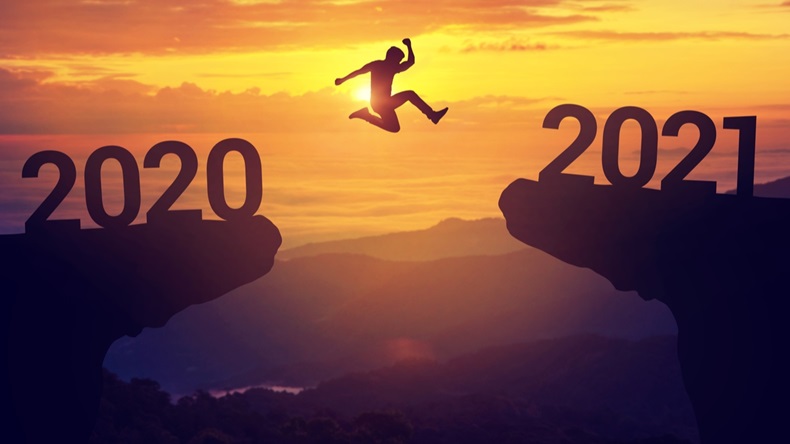 Silhouette man jump between 2020 and 2021 years with sunset background, Success new year concept