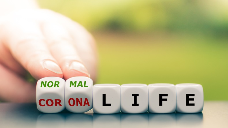 Back to normal. Hand turns dice and changes the expression "corona life" to "normal life".