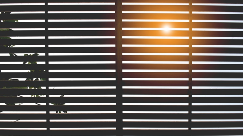 Venetian blinds silhouette with sun ray