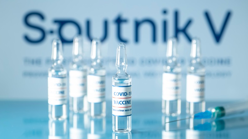 Concept of russian vaccine against COVID-19. Glass medical vials with liquid.