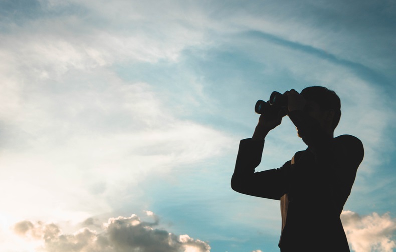 Silhouette of Businessman with binoculars to look for opportunities for success.