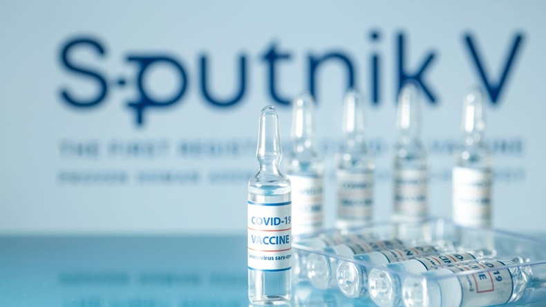 Sputnik 5 vaccine against COVID-19. Glass medical vials with liquid on the background Sputnik V company logo