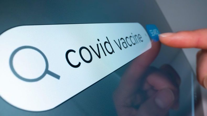 Close-up view of searching information on COVID 19 vaccine on the internet