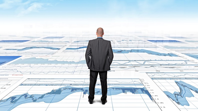 standing businessman and 3d abstract economy background