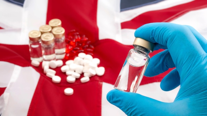 Stockpile drugs with doctor wearing latex gloves against UK flag