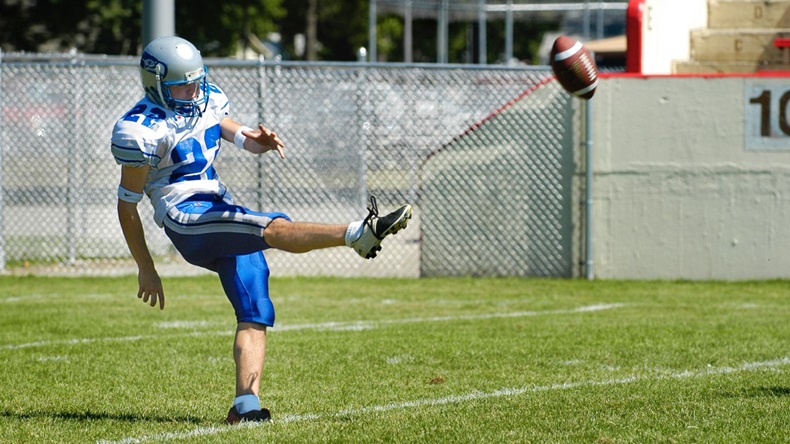 football player punting ball