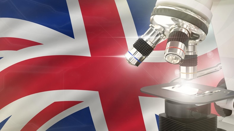 United Kingdom (UK) science development concept - microscope on flag background. 