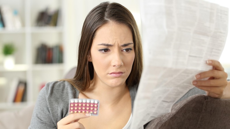 Woman reading contraceptive pills leaflet