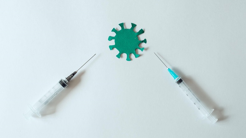The concept of a coronavirus vaccine. syringe and covid-19 virus on a white background
