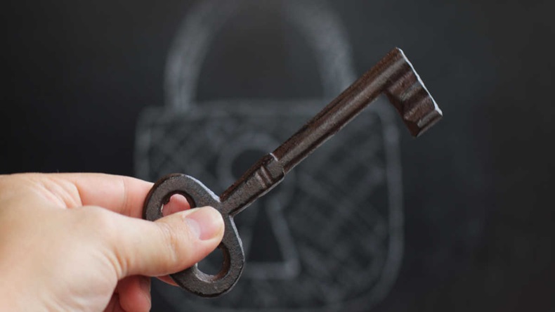 hand with a rare key, on the background of the 