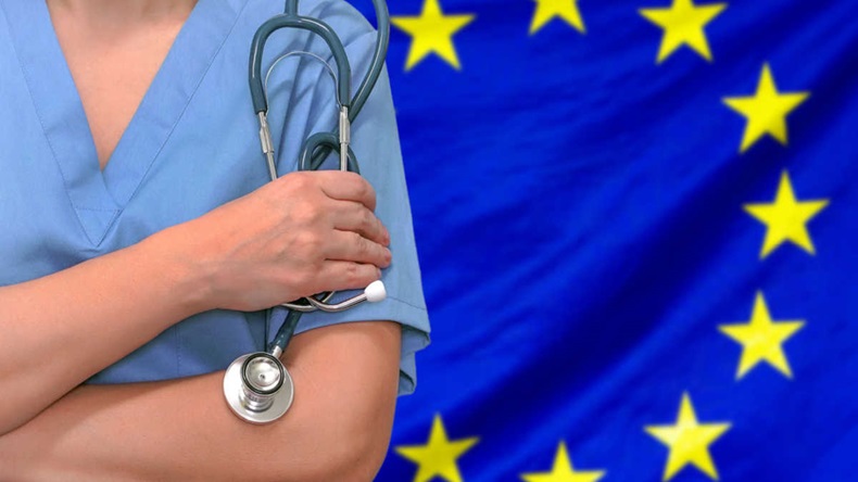 Female surgeon or doctor with stethoscope in hand on the background of the European Union flag