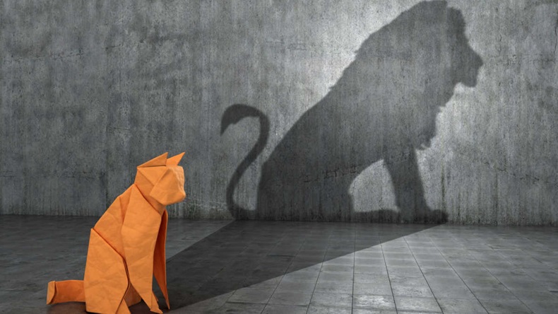 A paper figure of a cat that fills the shadow of a lion. 3D illustration