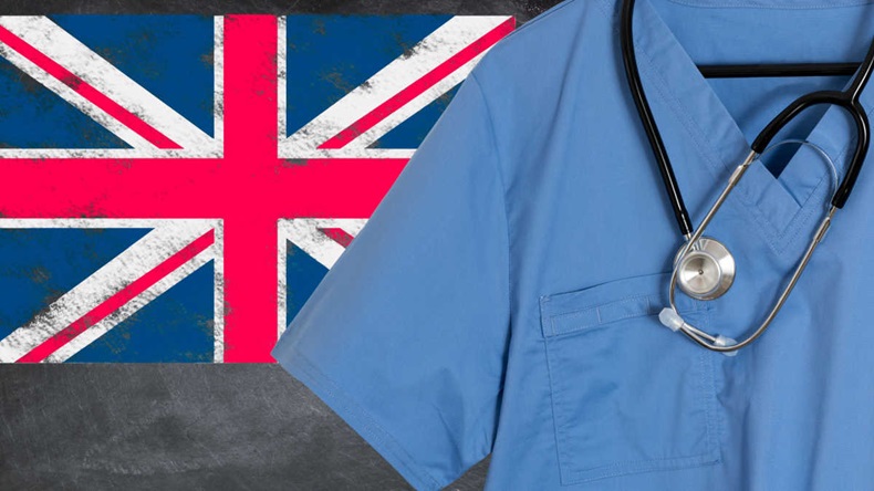 Blue scrubs with UK British flag for NHS medical workers under enormous strain due to coronavirus epidemic