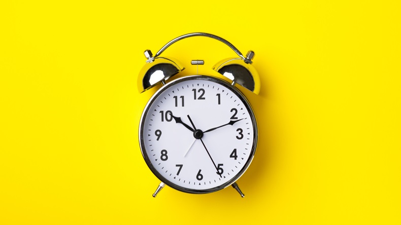 Retro alarm clock on bright yellow background - Image 