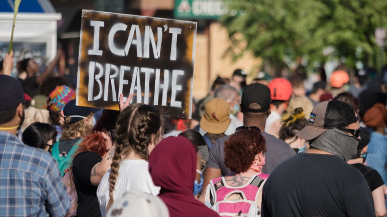 Minneapolis, Minnesota/United States of America - May 28, 2020: A group of protestors hold signs as they gather together to protest the police surrounding the death of George Floyd.