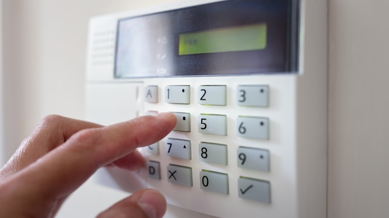 Security alarm keypad with person arming the system concept for crime prevention - Image 