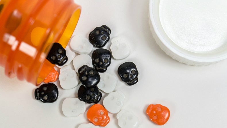 Skull-shaped pills in Halloween colors 