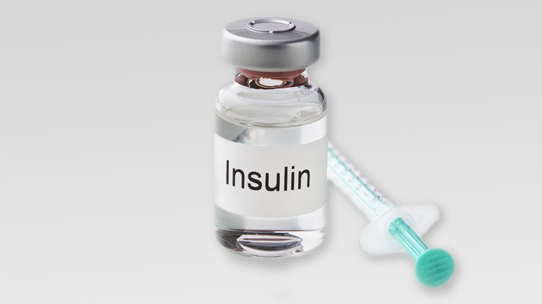 Insulin ampoule and a syringe isolated against white background